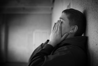 Man Covering His Face With His Hands